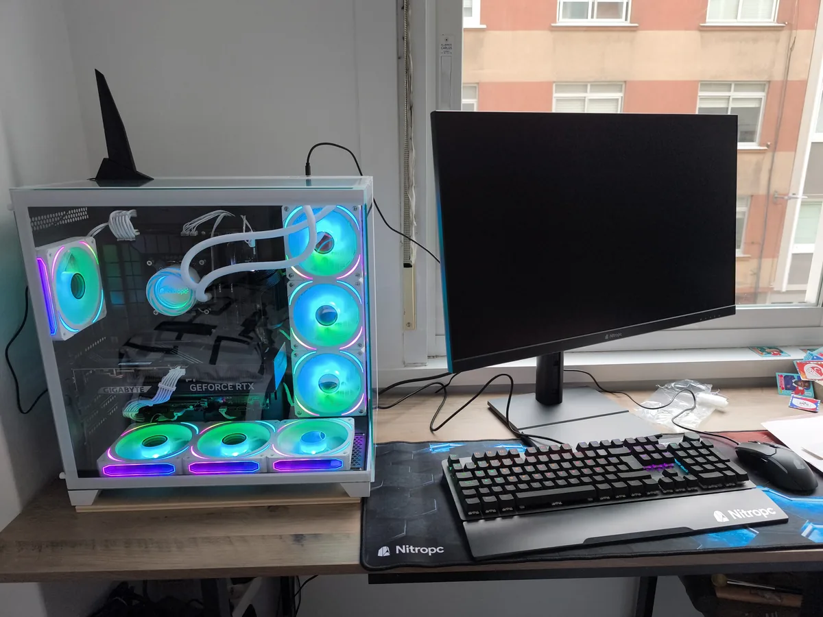 PC Nitropc blanc avec refroidissement liquide et ventilateurs RGB sur un bureau